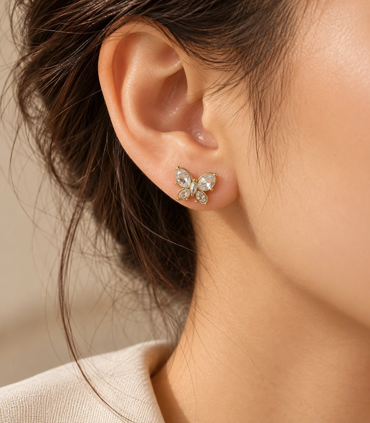 JIMIKI Gold Crystal Butterfly Stud Earrings — editorial worn styling #color_gold-tone