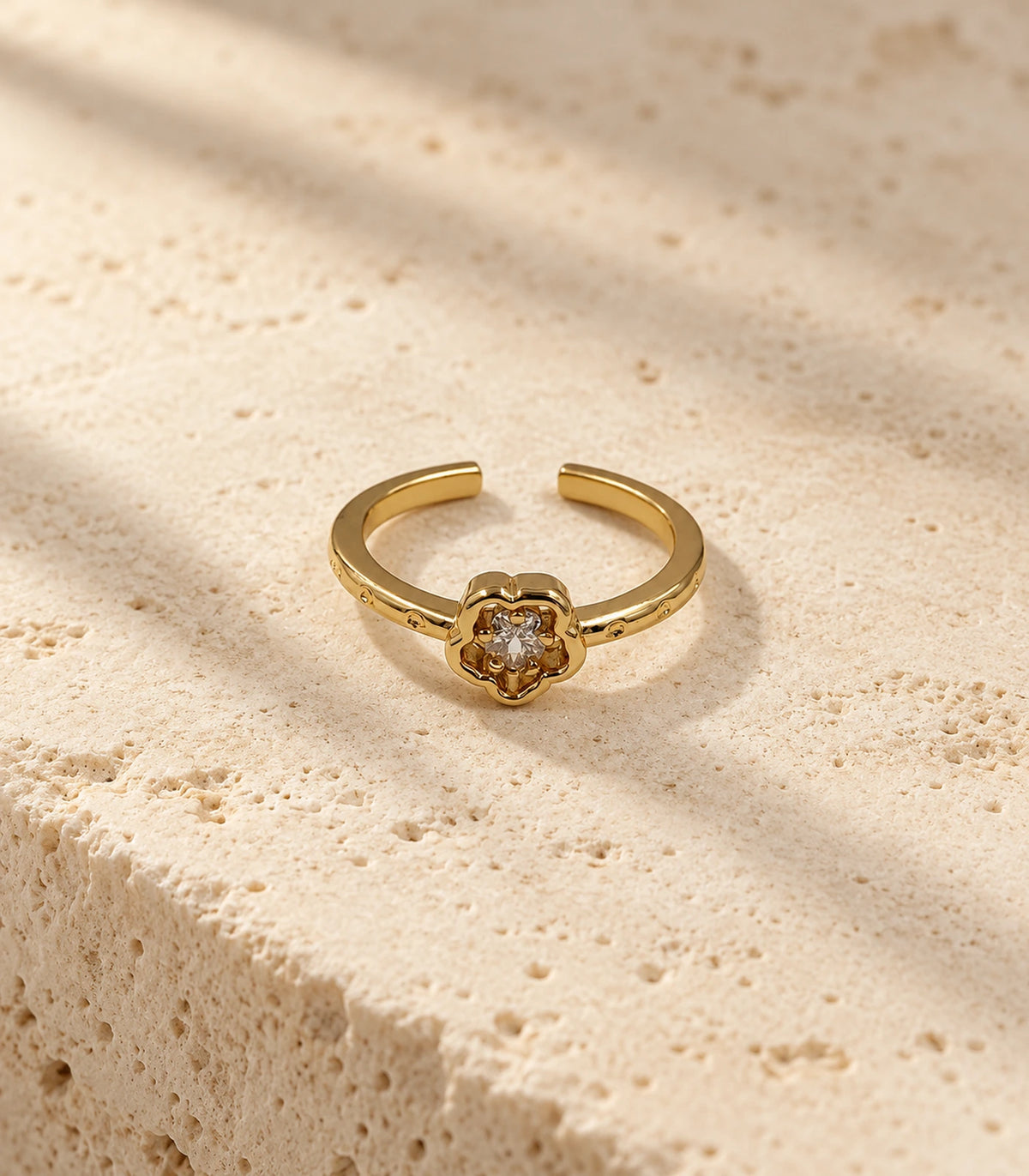 Gold Crystal Flower Open Ring on a textured stone surface