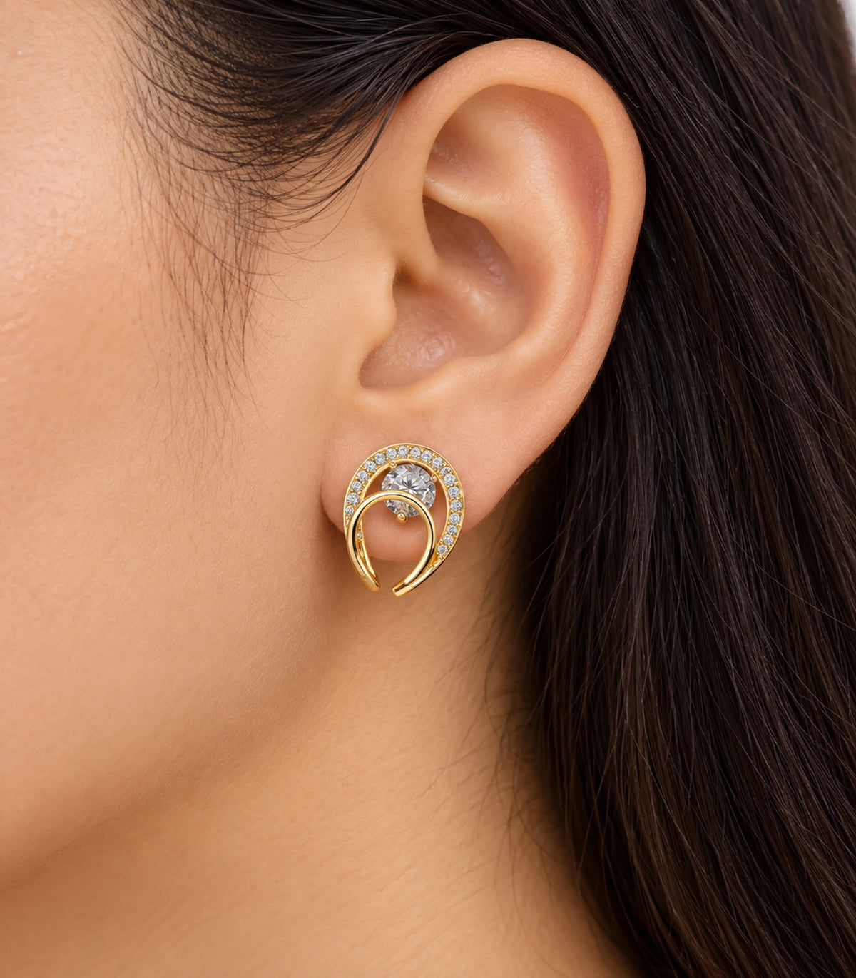 Gold-tone double-loop stud earring worn at the ear