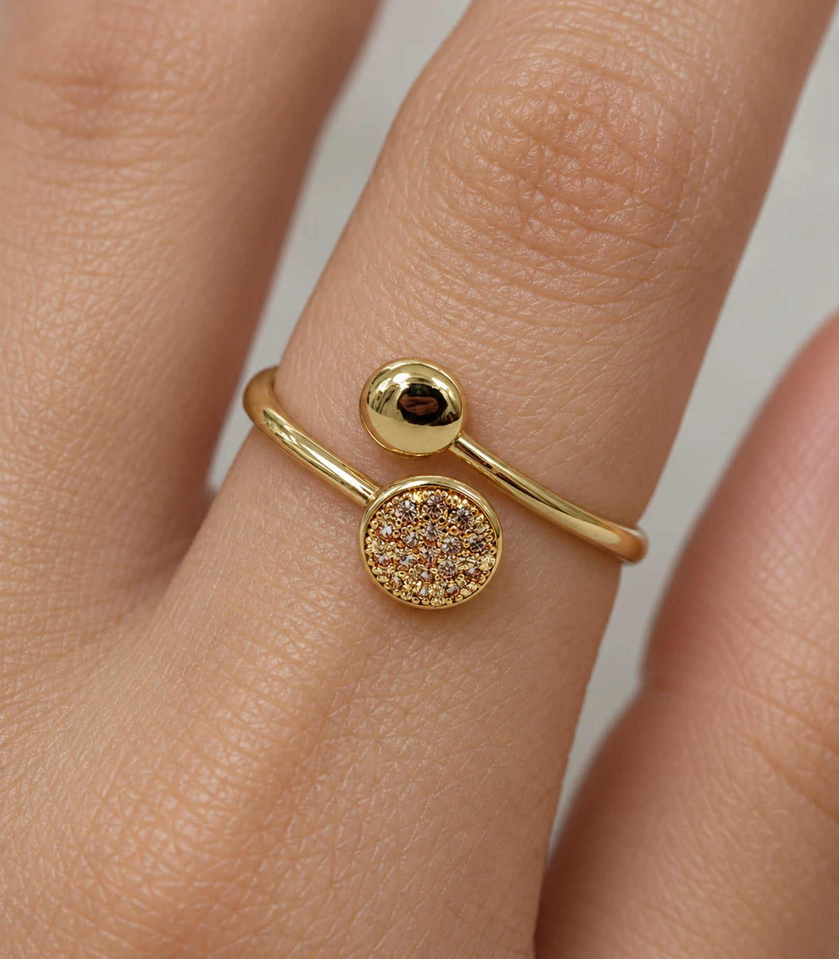 Closeup of Gold Dual Disc Crystal Open Ring worn on a finger