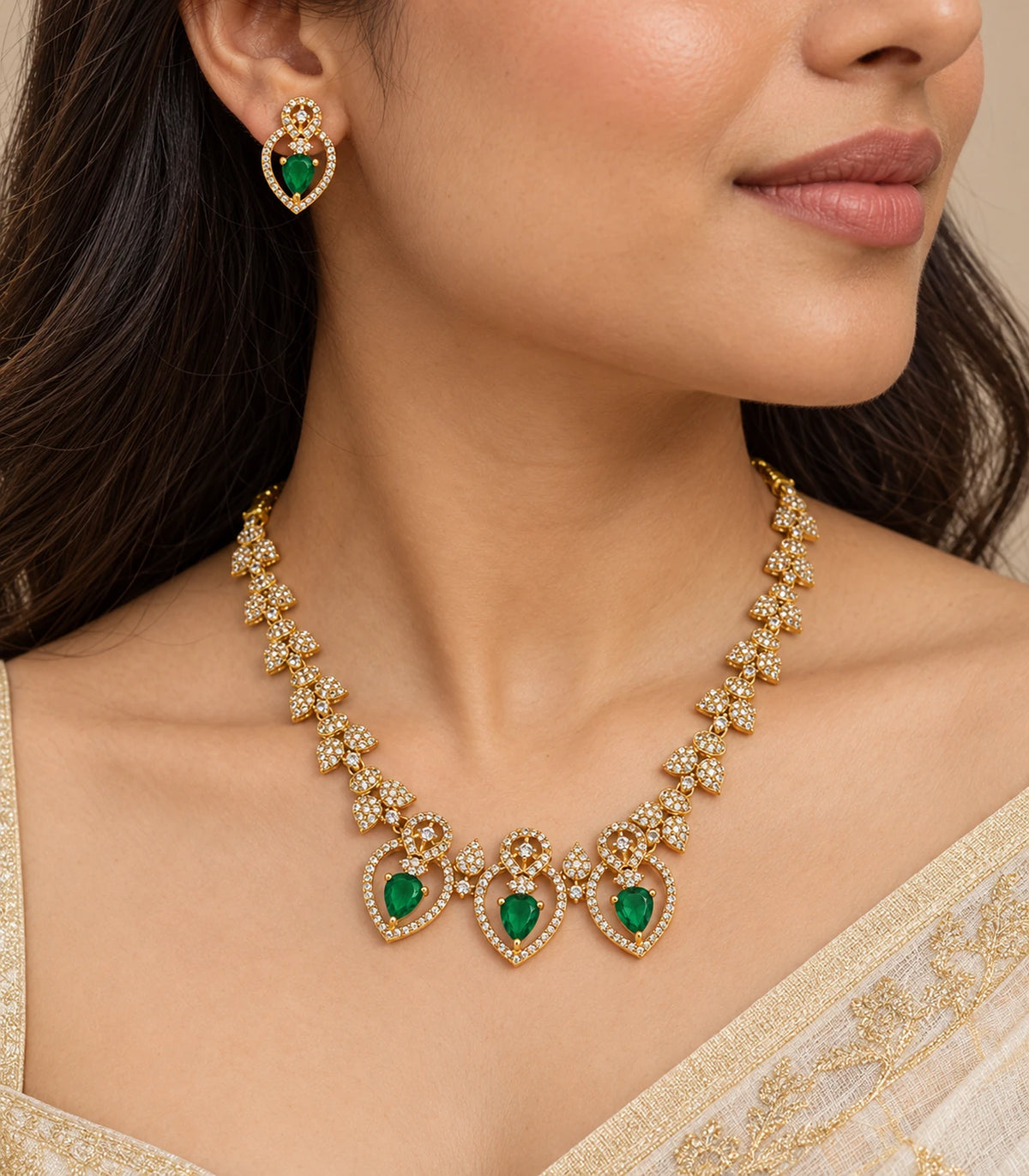 Close-up of Gold Emerald Heart Crystal Necklace Set and matching earring worn