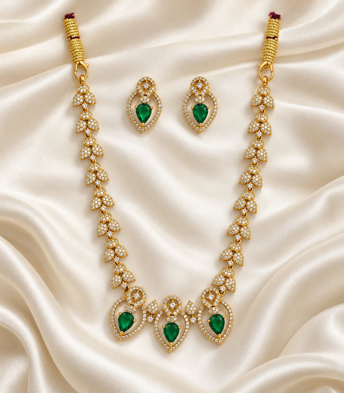 Gold Emerald Heart Crystal Necklace Set with both earrings on ivory fabric