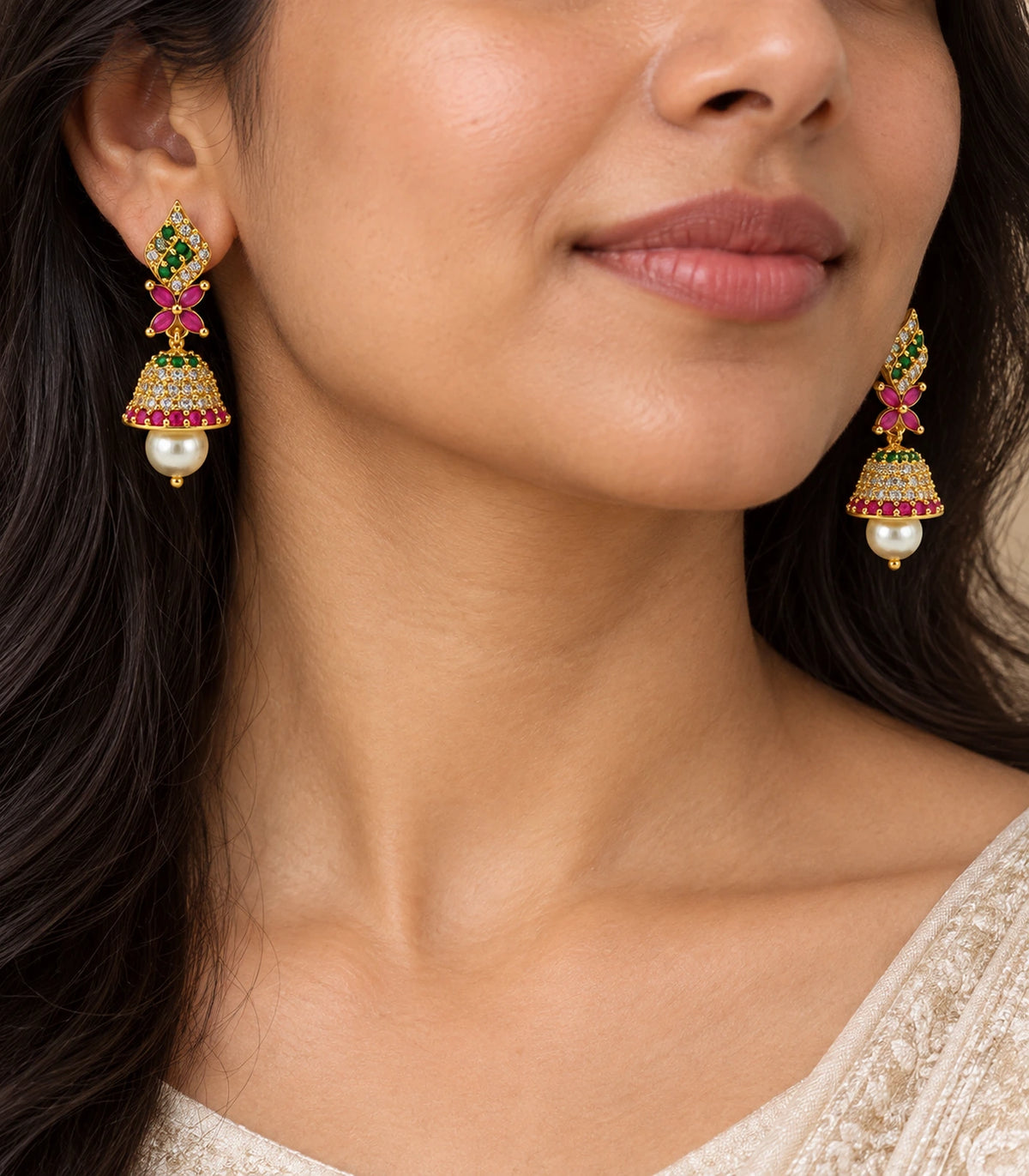 Close view of worn green flame studs, four magenta leaves, stone-set bells and pearl-style drops