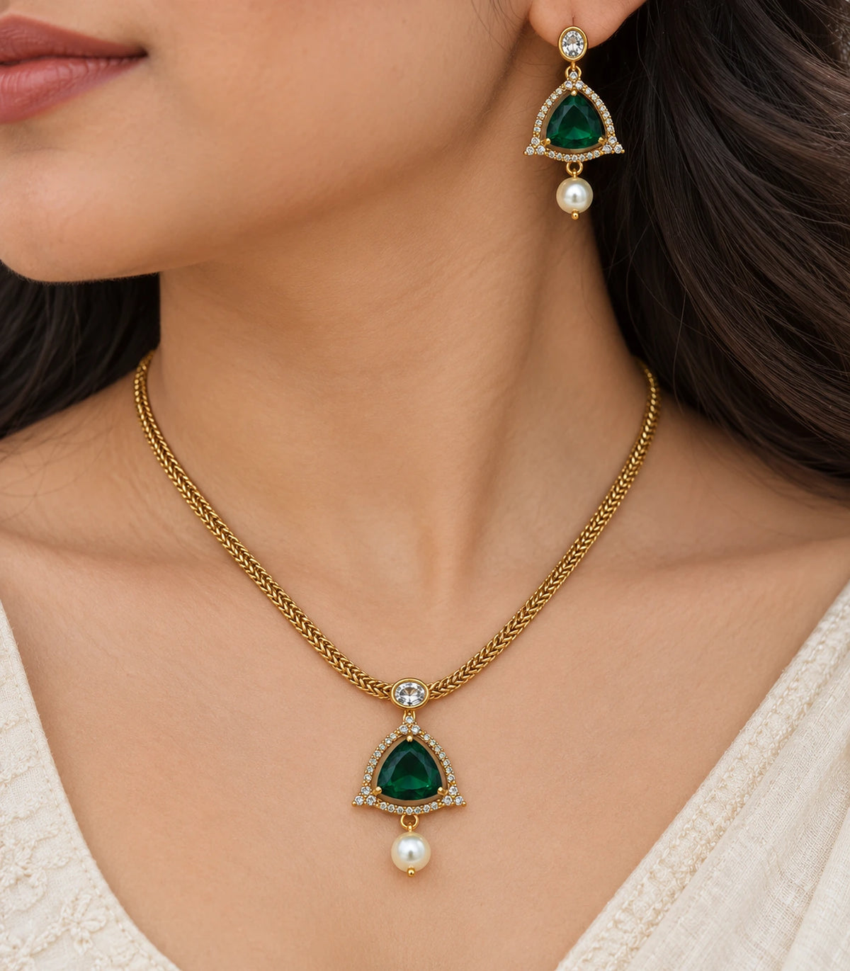 Closeup of the emerald-green halo earring and necklace pendant worn naturally