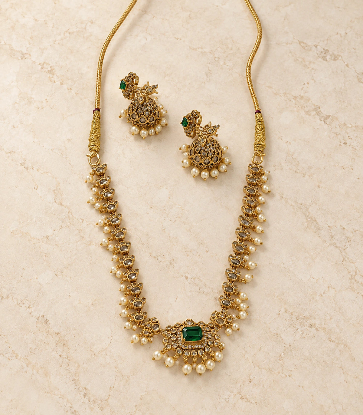 Gold Green Pearl Floral Necklace Set arranged on a stone-like surface
