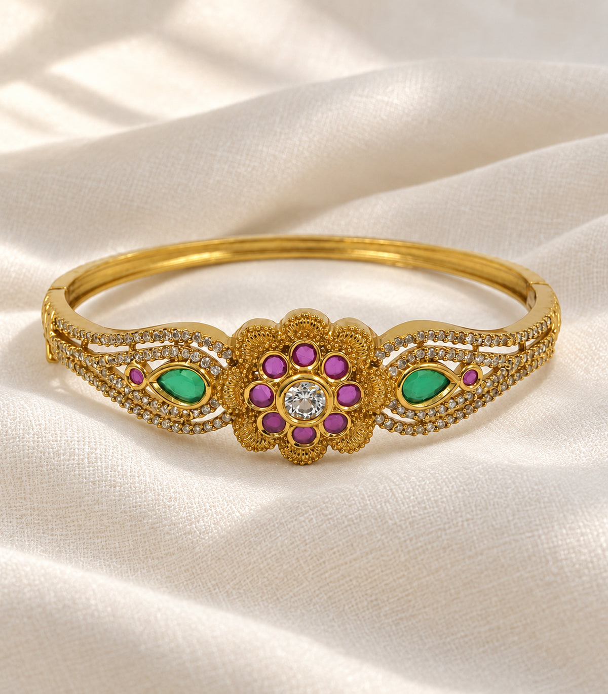 Gold magenta and green floral bangle in an editorial flatlay