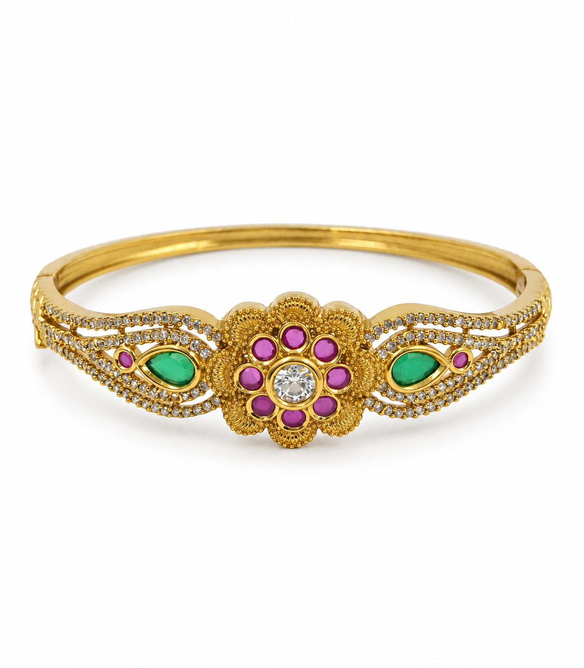 Gold-tone bangle with eight magenta floral stones and green teardrop accents on a white background