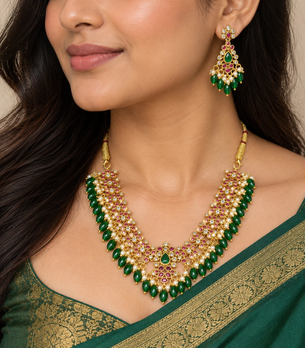 Worn closeup of the necklace and matching earring with green drops and white pearl-look fringe