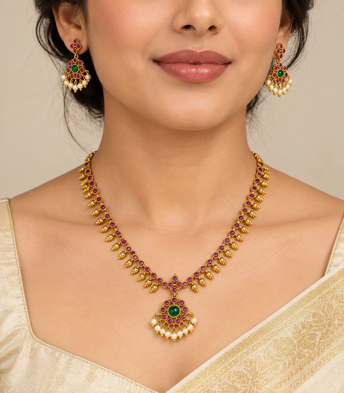 Magenta and green necklace set with matching earrings worn with an ivory outfit