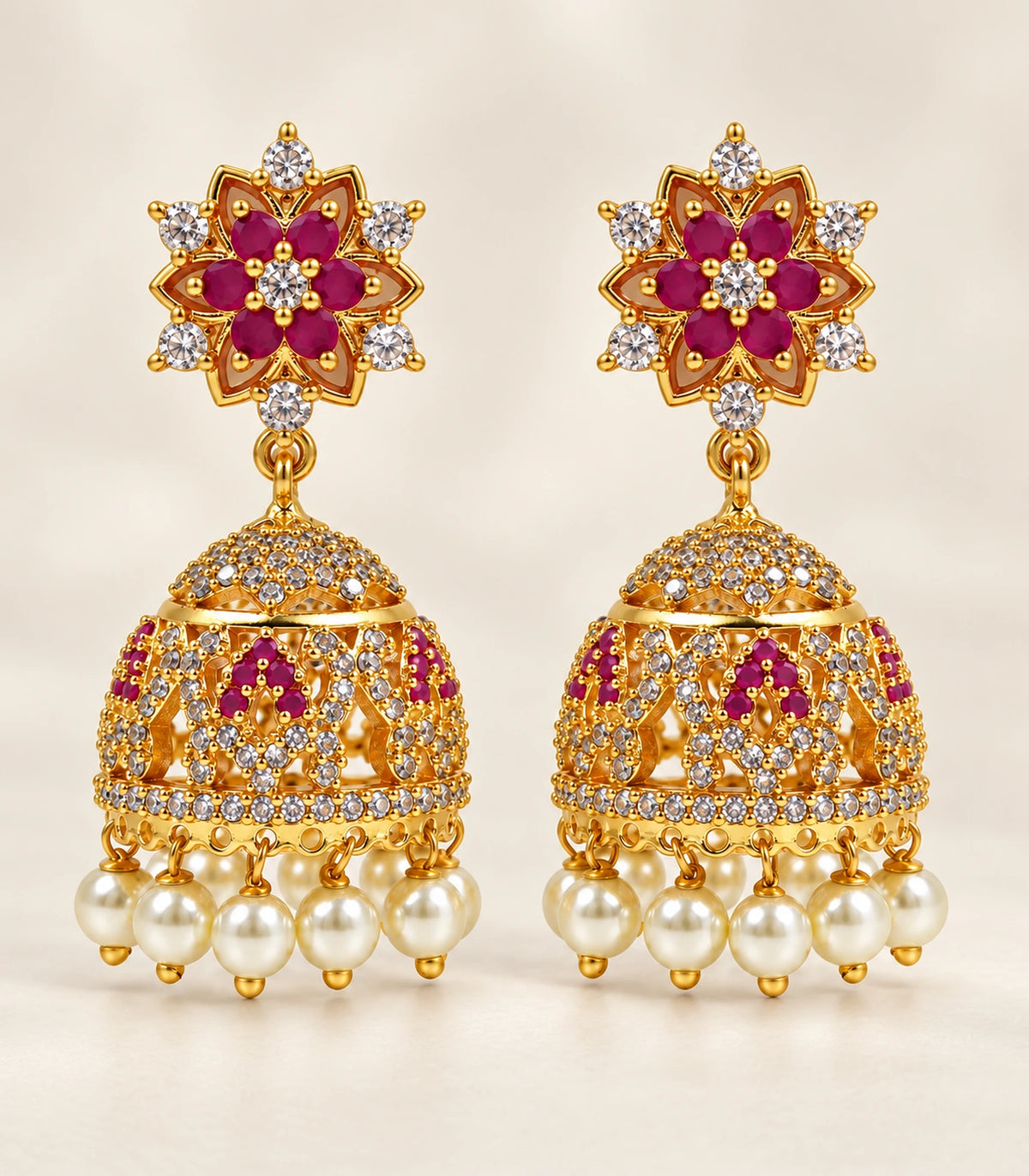 Gold Magenta Floral Crystal Pearl Jhumka Earrings — complete pair on a warm neutral background