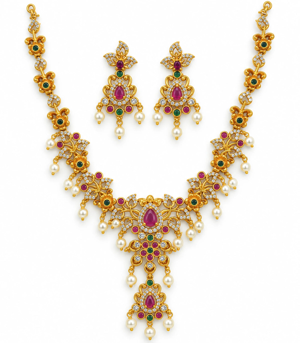 Gold-tone magenta floral necklace set with green accents and white pearl-look drops, with its matching pair of earrings on white.