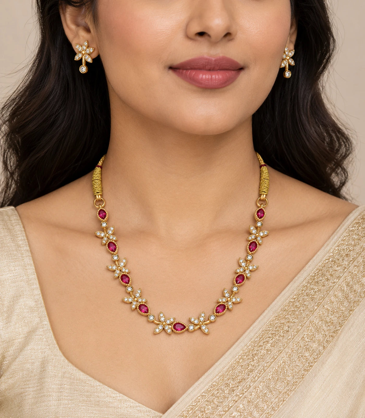 Gold Magenta Leaf Crystal Necklace Set worn with matching small clear earrings and an ivory outfit