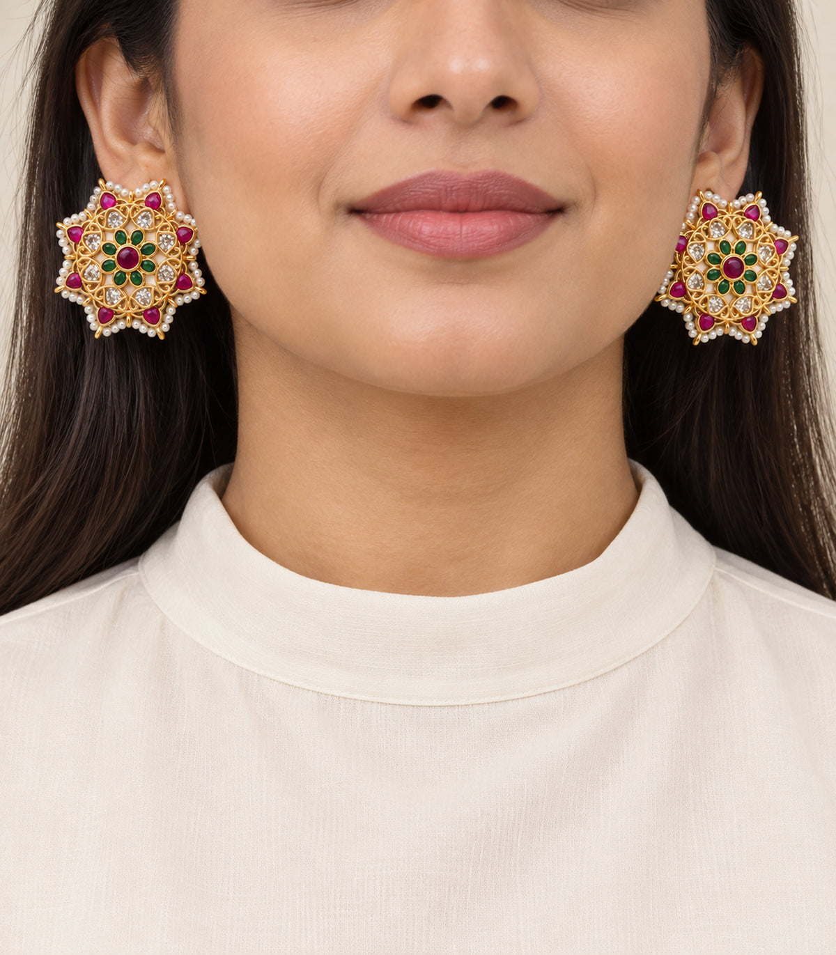Gold magenta and green pearl border stud earrings shown on a model