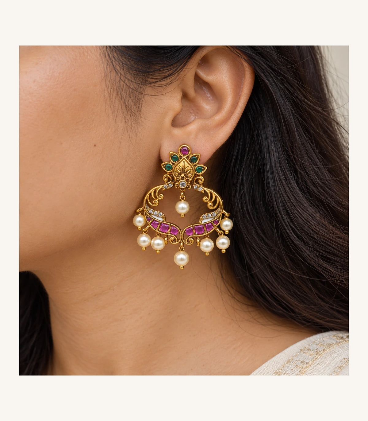 Worn closeup of the green leaf top, magenta band and pearl drops