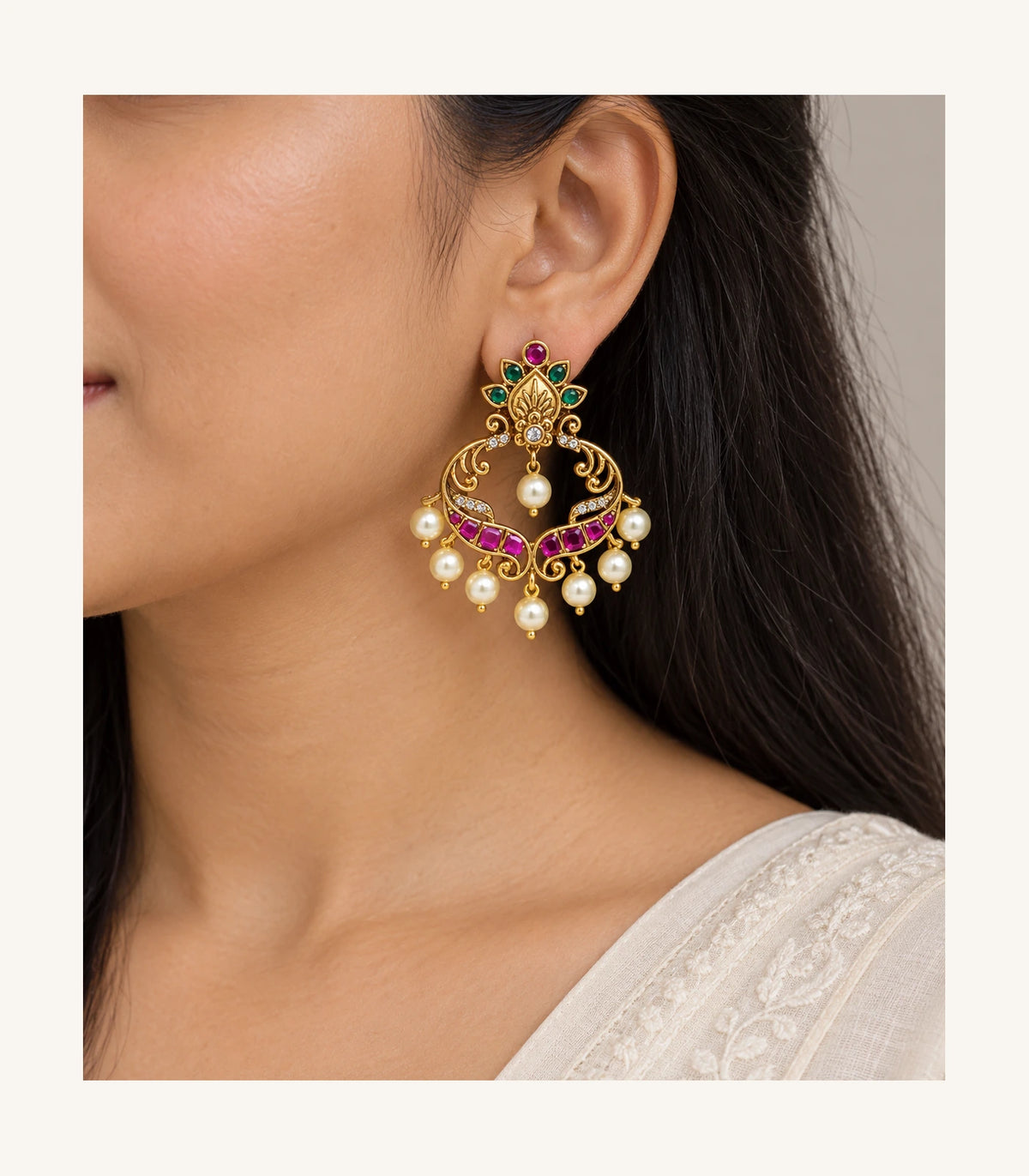 Single gold magenta and green pearl-drop earring worn naturally, side view