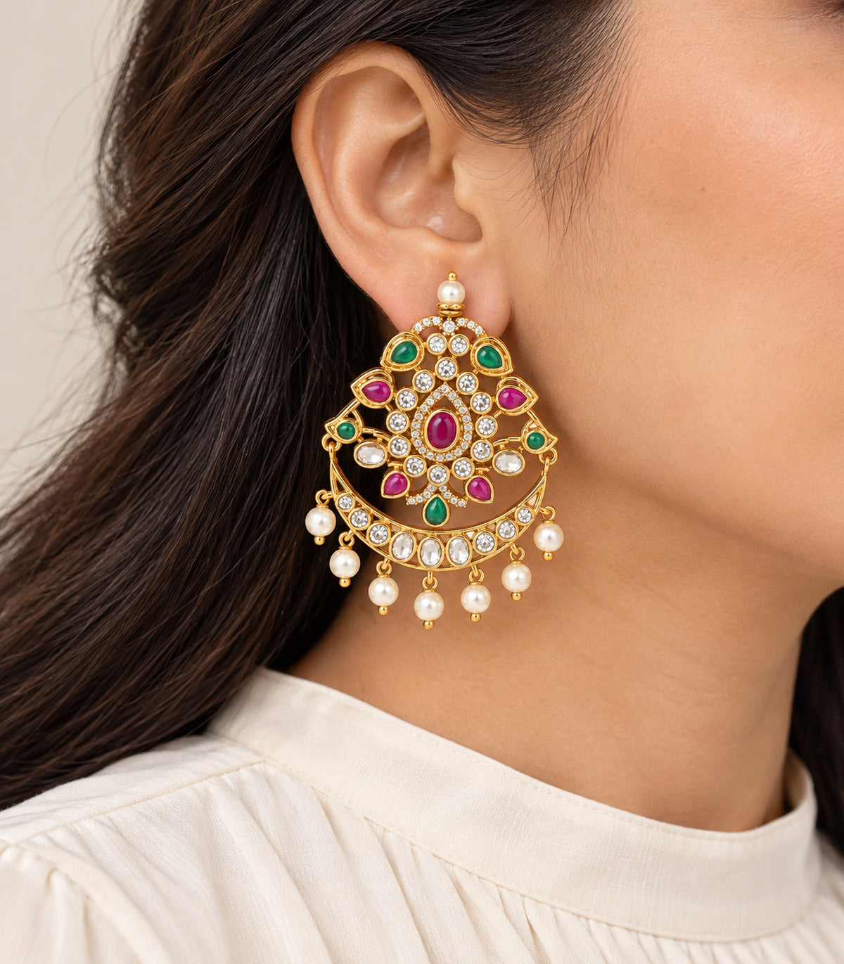 Gold magenta and green chandbali earring worn in a single-ear side view