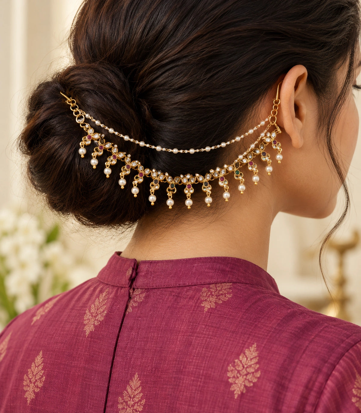 Gold tone triple-leaf pearl ear chain worn with a modest magenta silk outfit