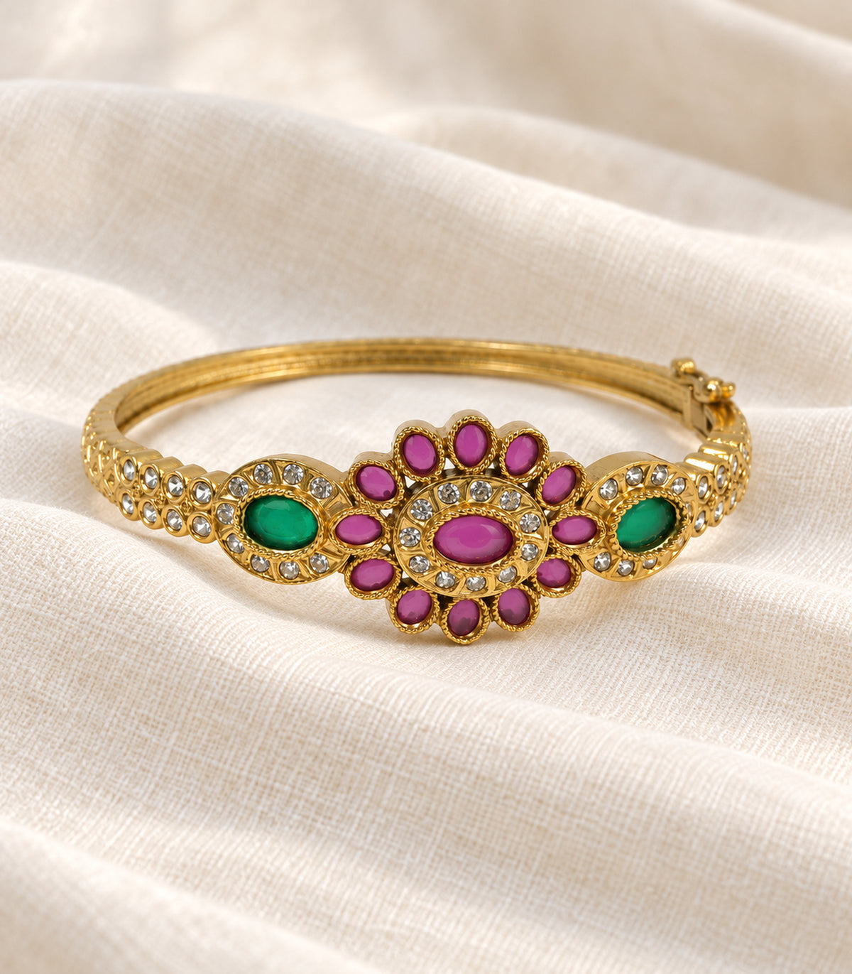 Single gold magenta oval flower green halo bangle on ivory fabric