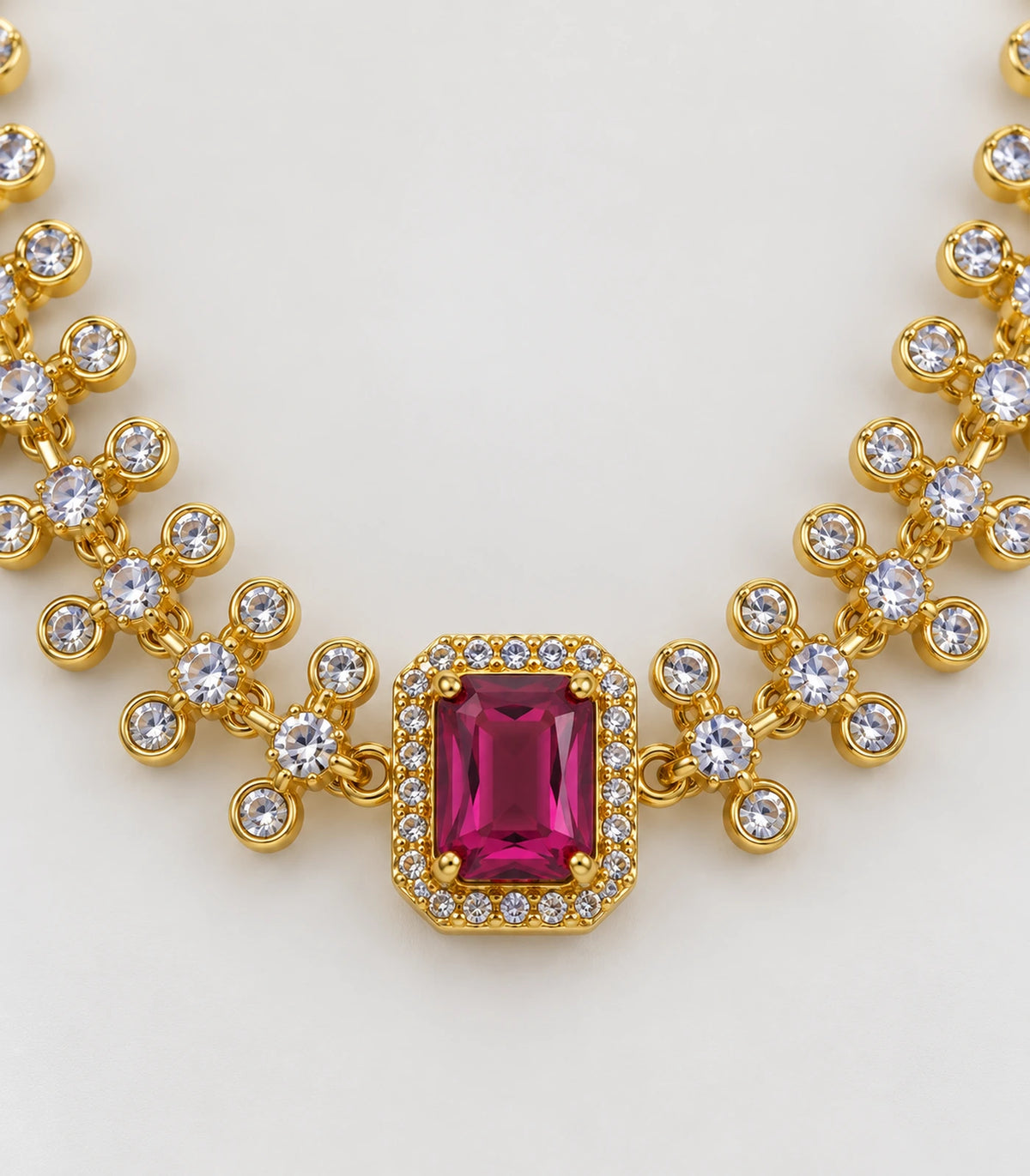 Detail of the magenta bordered necklace centre and clear round crystal links