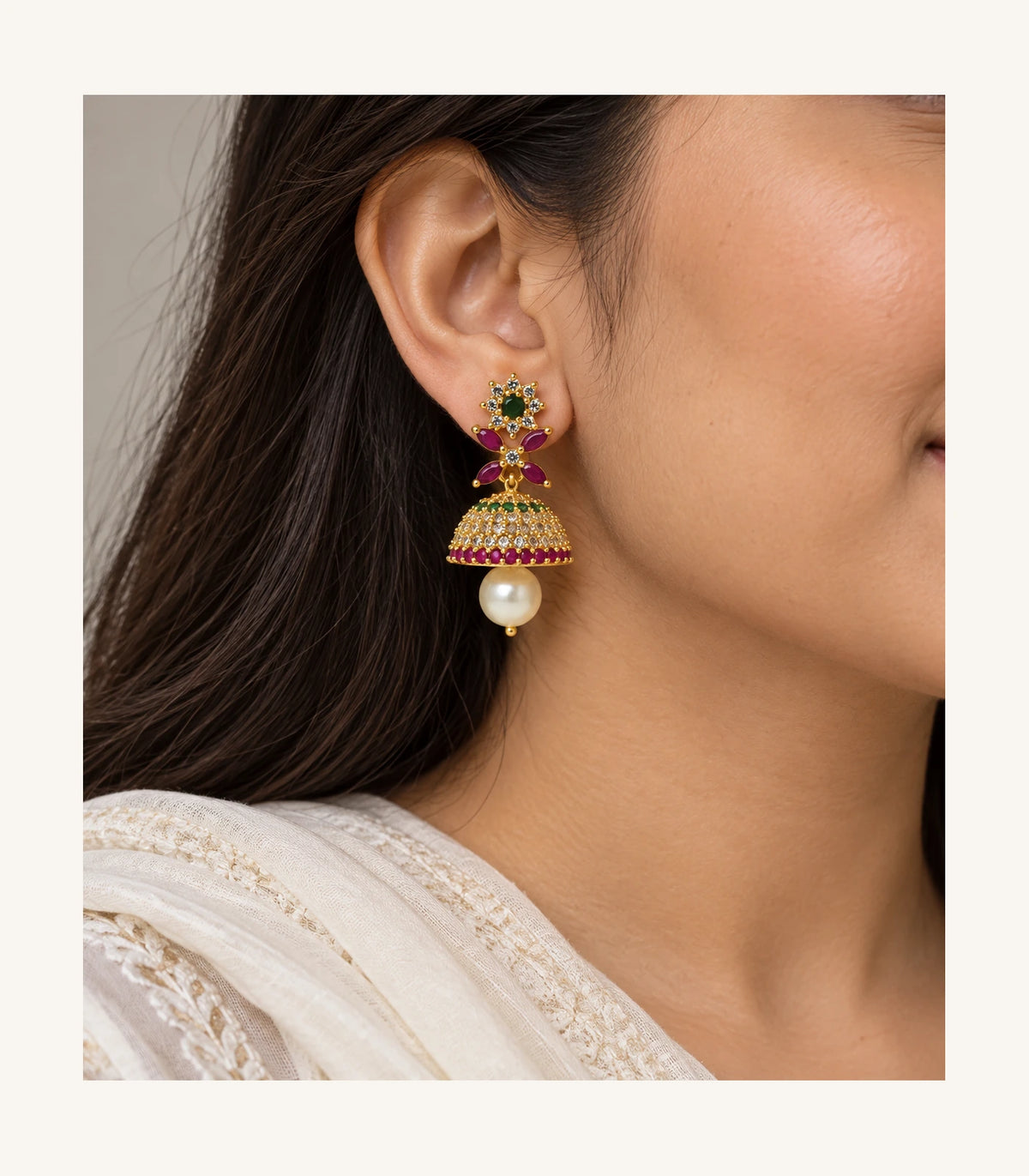 Gold multicolor floral earring worn at the ear