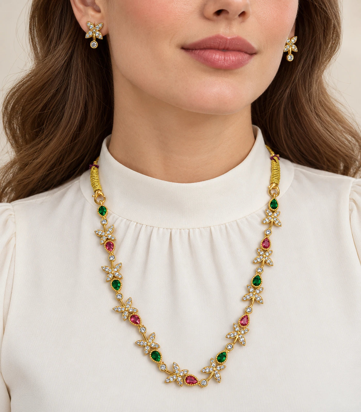 Gold multicolor floral necklace and matching earrings worn with a white blouse