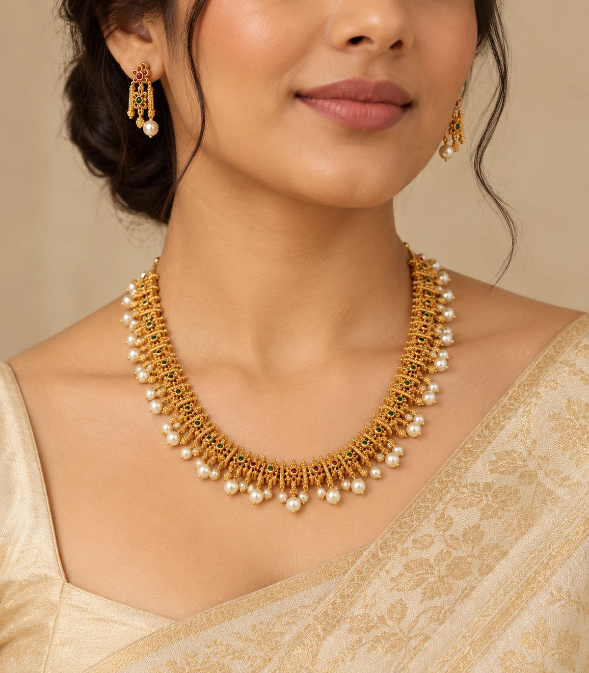 Gold multicolor pearl fringe necklace set worn with matching earrings in an editorial view