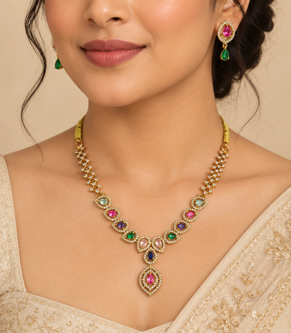 Gold-tone multicolor teardrop necklace set worn with matching pink and green drop earrings