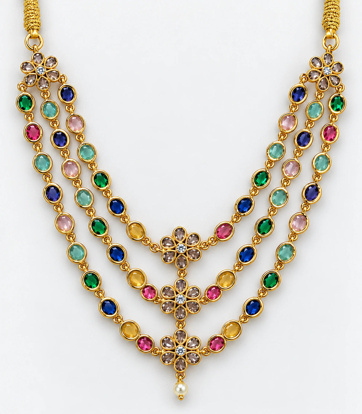 Close detail of three multicolor necklace strands, central floral motifs and pale round drop