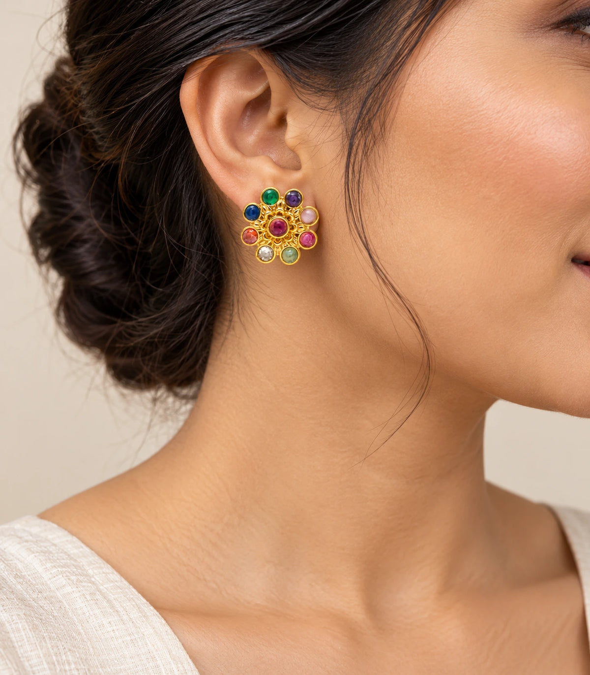 Gold-tone multicolour flower stud earring worn at the ear