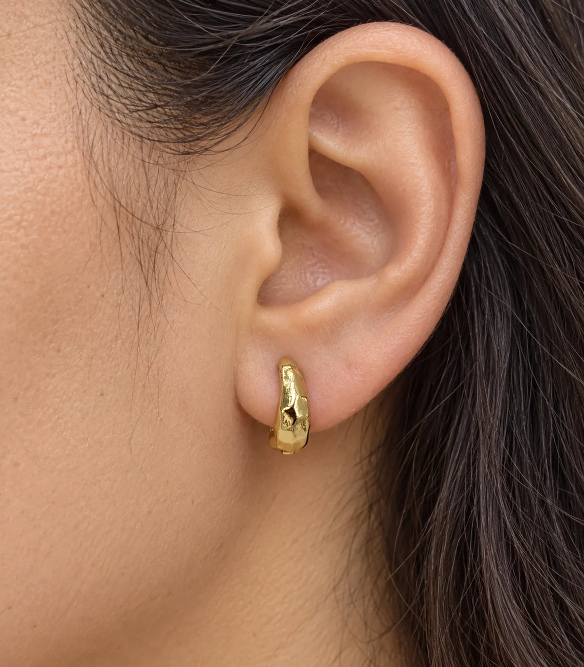 JIMIKI Gold Organic Hammered Huggie Earrings — worn close-up detail #color_gold-tone