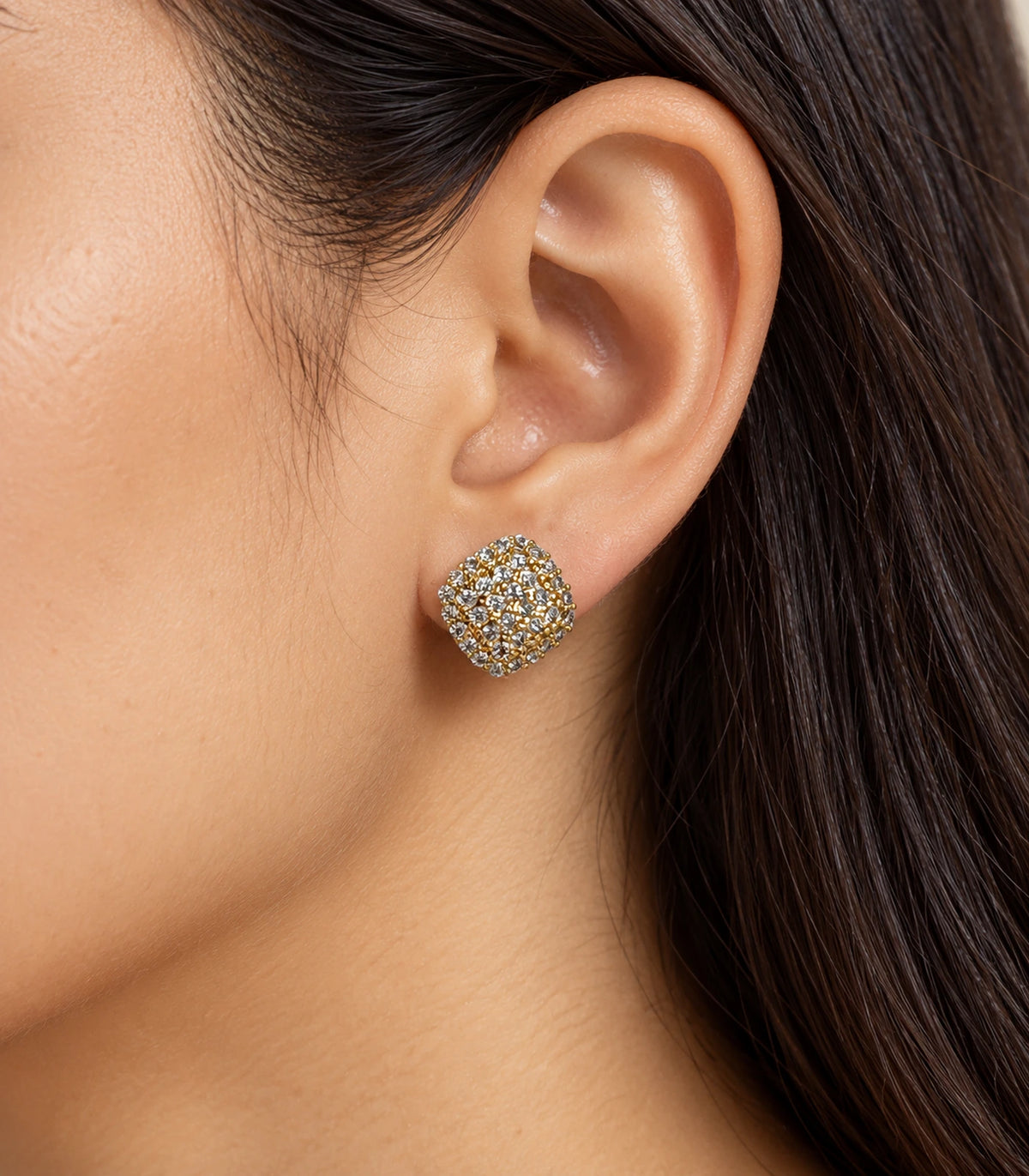 Gold-tone cushion cluster stud earring in an editorial ear detail