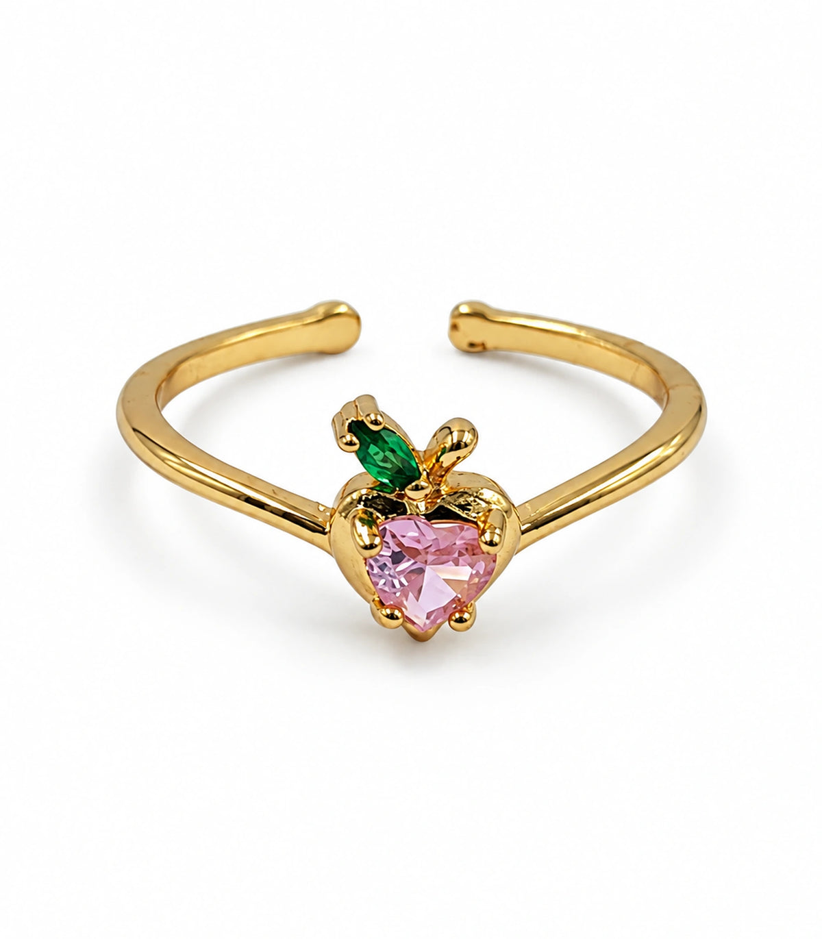 Gold-tone open ring with a pink heart-shaped stone, green leaf and stem on white