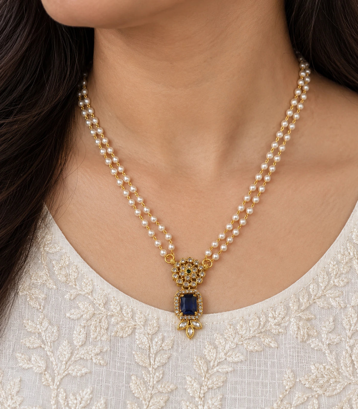 Close view of the Gold Sapphire Kundan Double Pearl Necklace pendant worn at the neckline