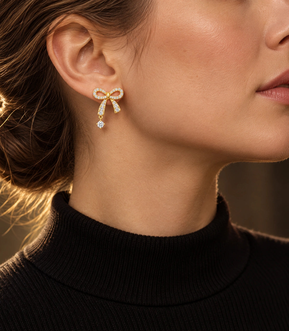 JIMIKI Gold-Tone Asymmetric Crystal Bow Round Drop Stud Earrings in Gold Tone, editorial model view