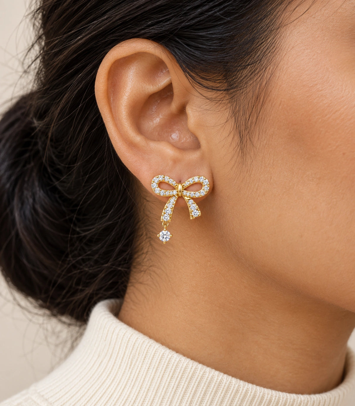 JIMIKI Gold-Tone Asymmetric Crystal Bow Round Drop Stud Earrings in Gold Tone, model wearing view