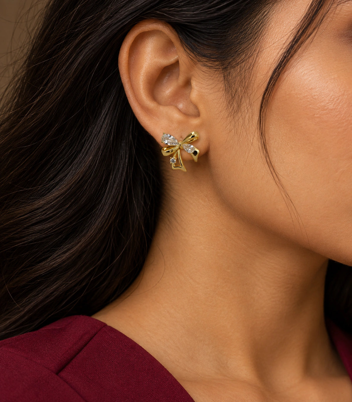 JIMIKI Asymmetric Crystal Bow Stud Earring Pair in Gold / Clear, editorial model view #color_gold / clear