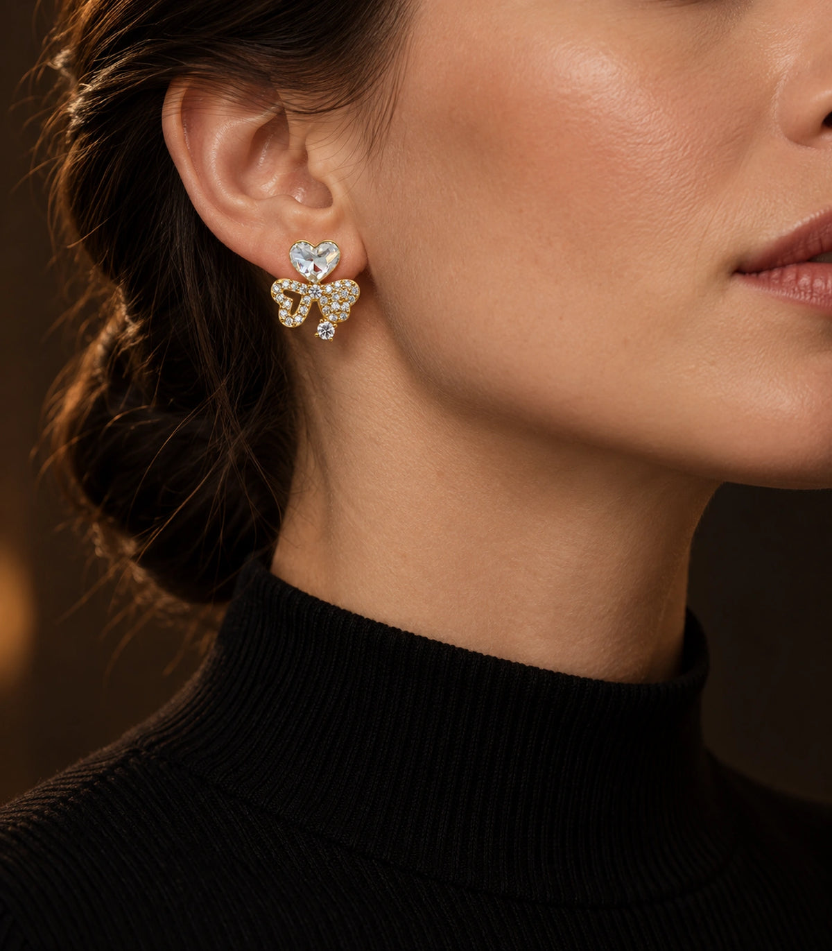 JIMIKI Gold-Tone Asymmetric Crystal Heart Bow Stud Earrings in Gold Tone, editorial model view