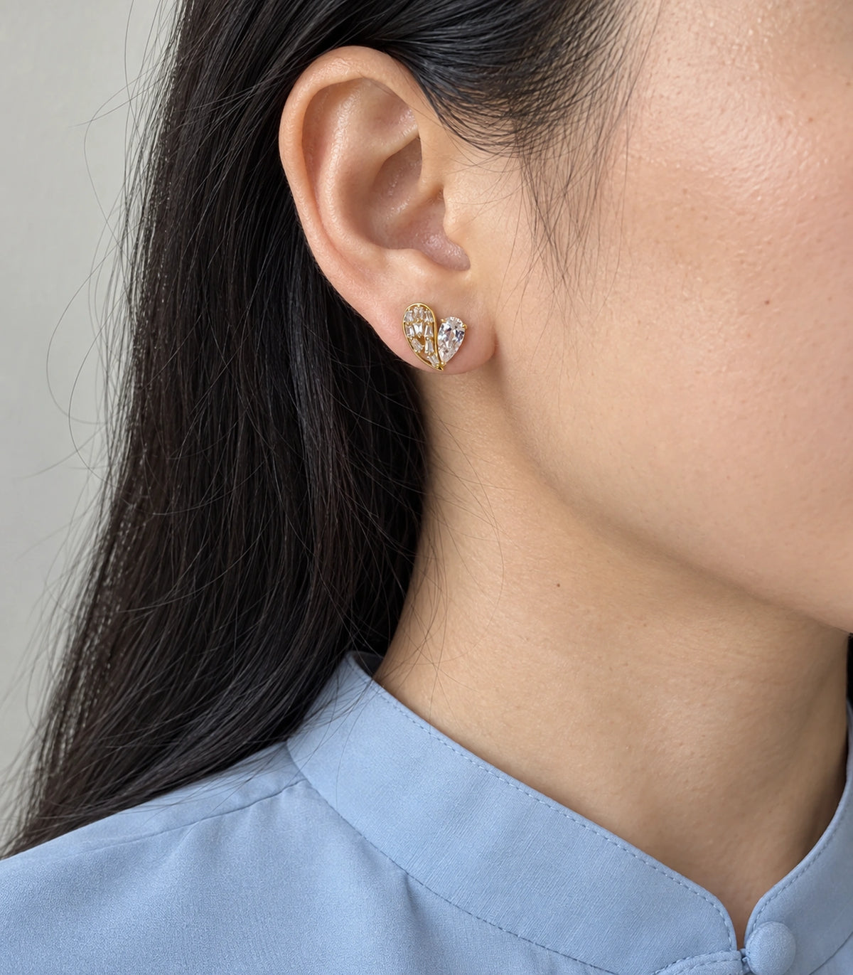 JIMIKI Asymmetric Crystal Heart Stud Earring Pair in Gold Tone, editorial model view #color_gold tone