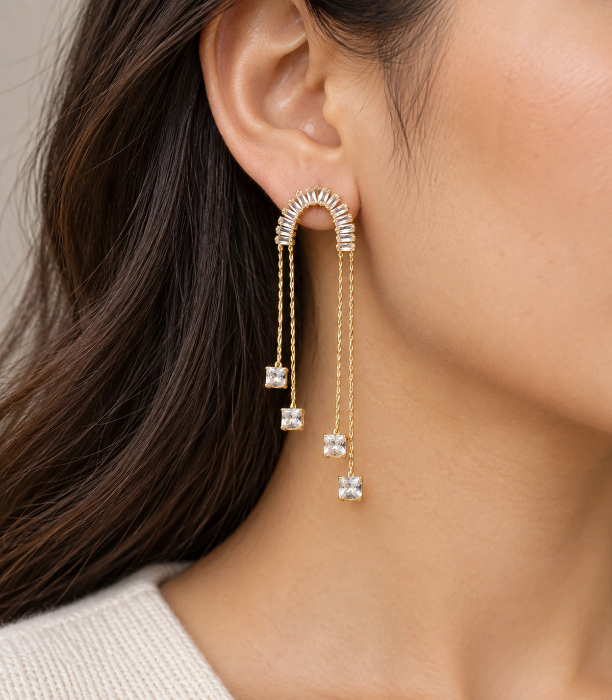 JIMIKI Gold-Tone Crescent Crystal Chain Drop Earrings — worn on the ear #color_gold-tone / clear