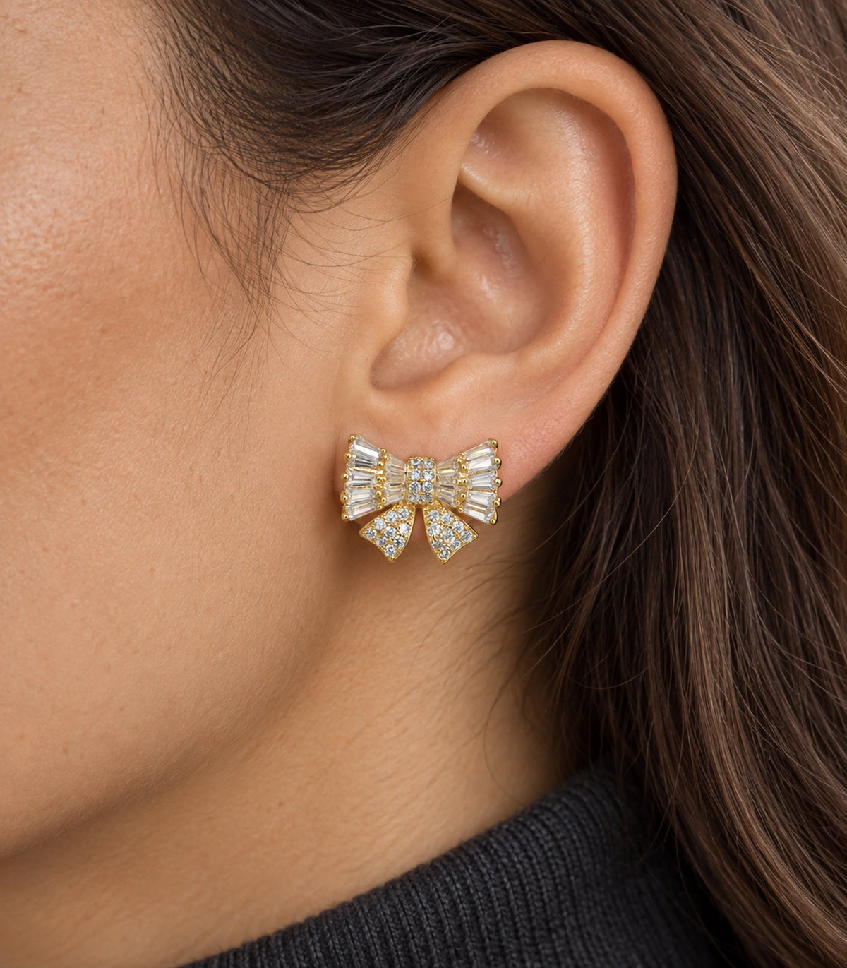 JIMIKI Baguette Crystal Bow Stud Earring Pair in Gold-tone, close-up detail #color_gold-tone