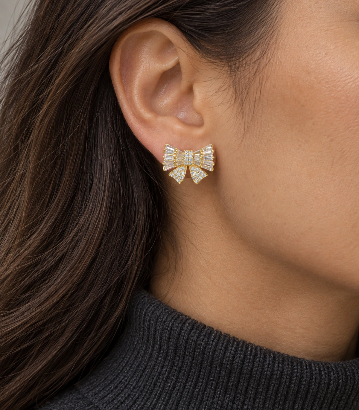 JIMIKI Baguette Crystal Bow Stud Earring Pair in Gold-tone, model wearing view #color_gold-tone