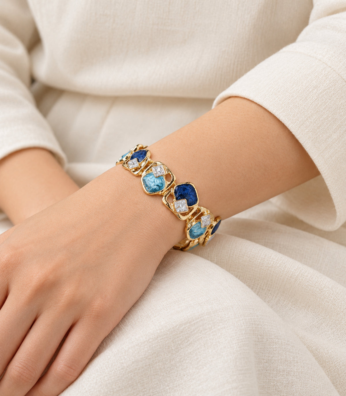 Gold-tone blue geometric openwork bracelet — editorial model view