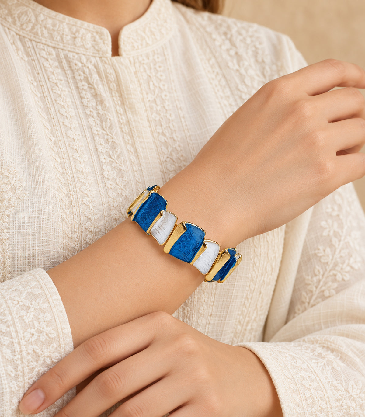 JIMIKI gold-tone blue and white rectangle panel bracelet — editorial model