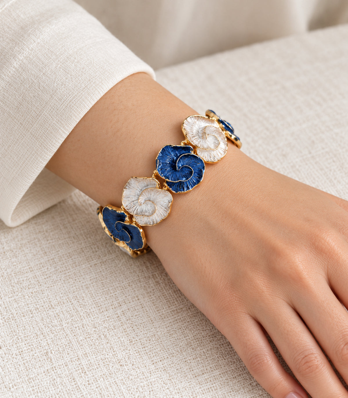 Gold-tone blue and white spiral-shell bracelet — model view
