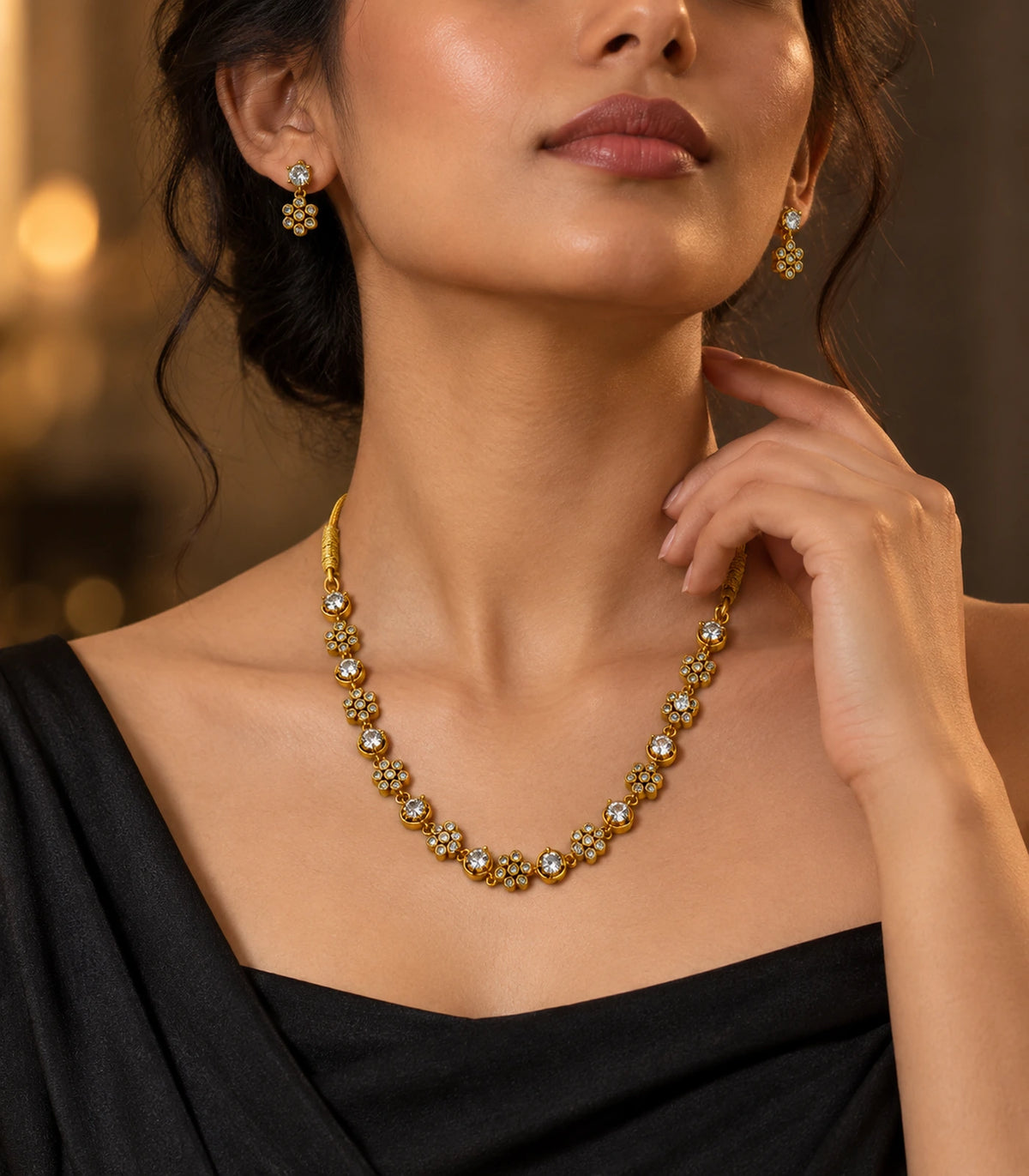 Gold-tone floral cluster necklace set worn with a black outfit