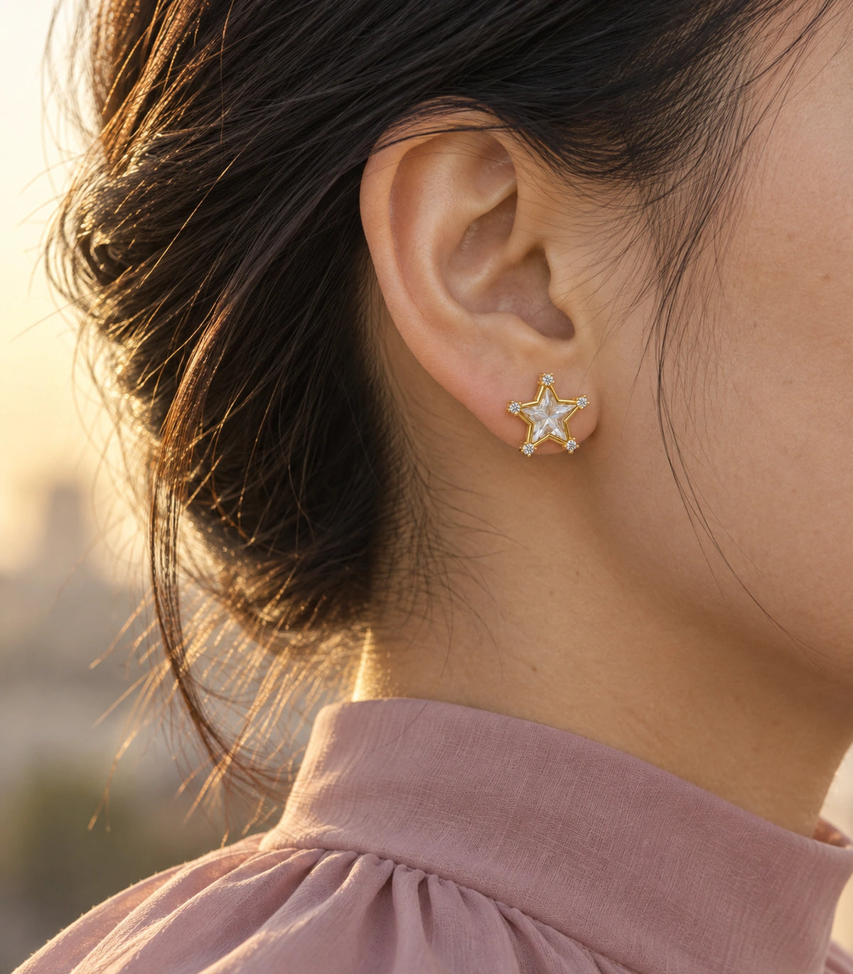 JIMIKI Crystal Star Stud Earring Pair in Gold tone, editorial model view #color_gold tone