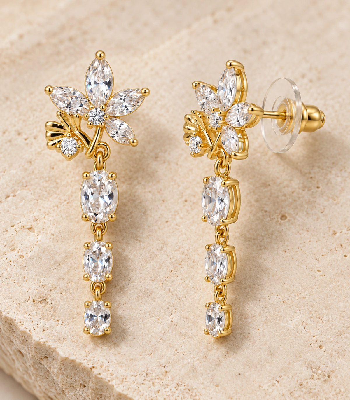 JIMIKI Floral Triple Oval Drop Earring Pair in Gold tone / clear, editorial flat lay #color_gold tone / clear