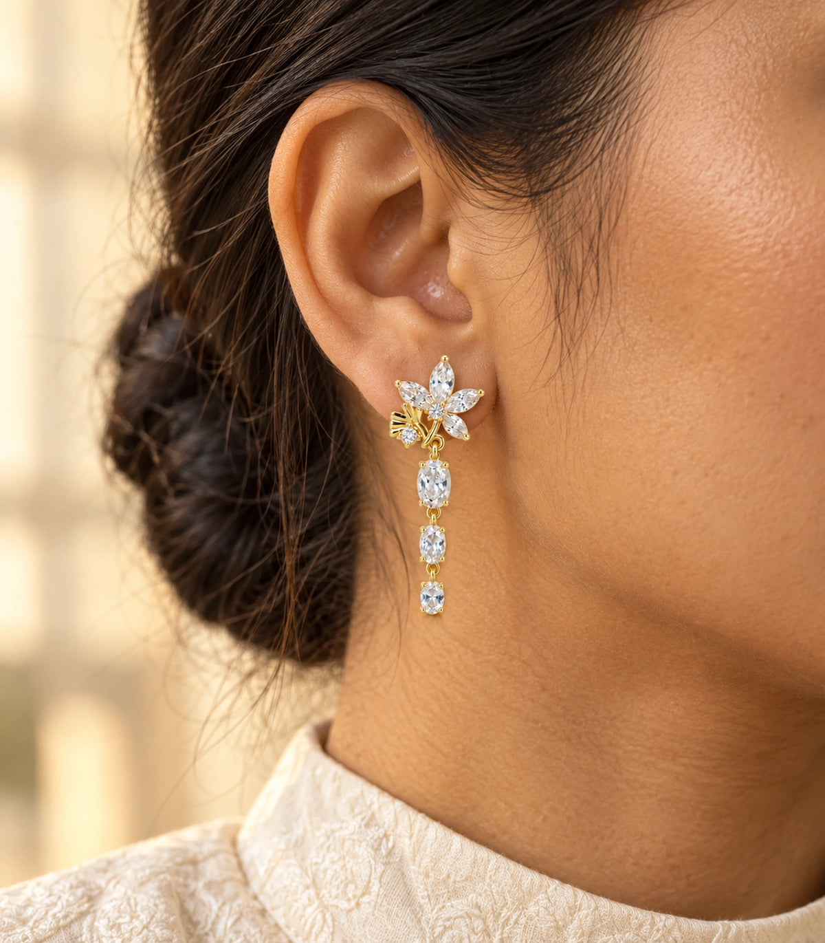 JIMIKI Floral Triple Oval Drop Earring Pair in Gold tone / clear, editorial model view #color_gold tone / clear