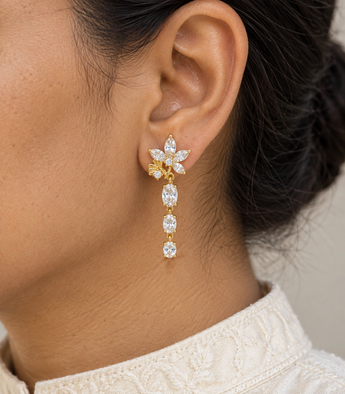 JIMIKI Floral Triple Oval Drop Earring Pair in Gold tone / clear, model wearing view #color_gold tone / clear