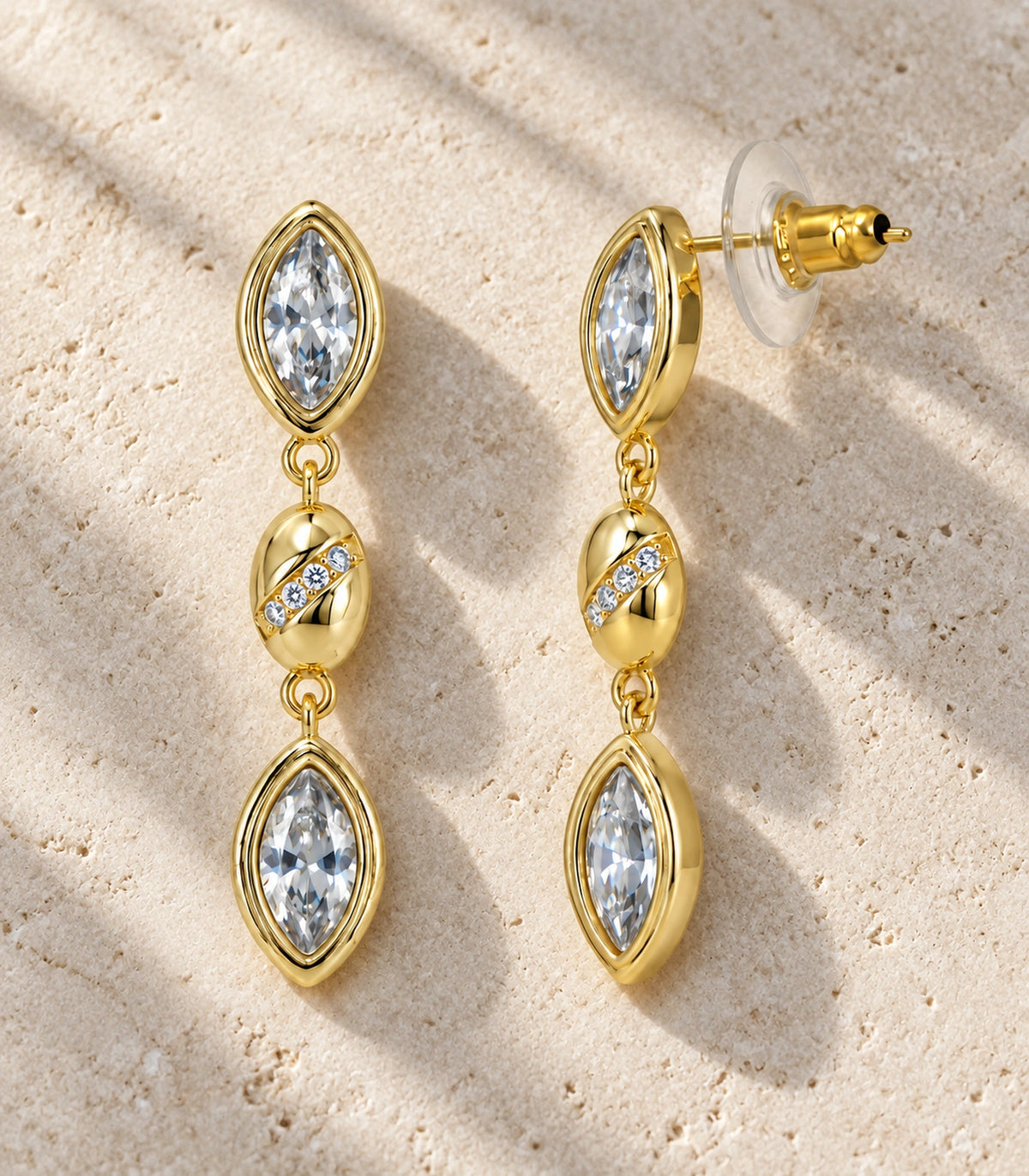 JIMIKI Marquise Crystal Oval Link Drop Earring Pair in Gold-tone, editorial flat lay #color_gold-tone